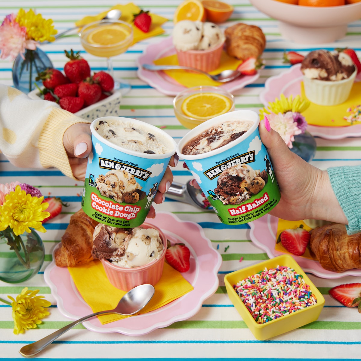 Ben & Jerry's Half Baked and Chocolate Chip Cookie Dough ice cream pints on a bright summery background.