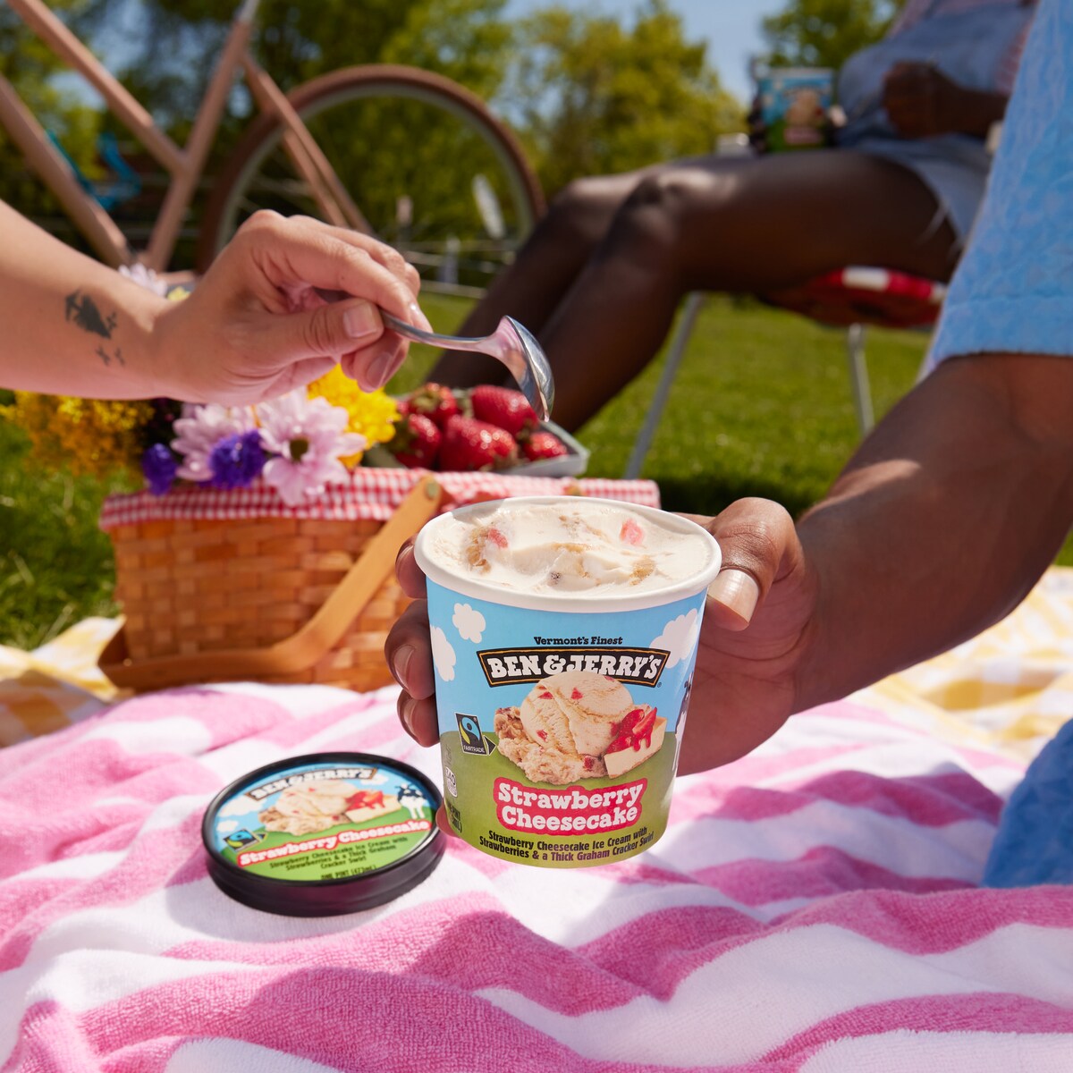 Ben & Jerry's Strawberry Cheesecake ice cream at an outdoor summer picnic.