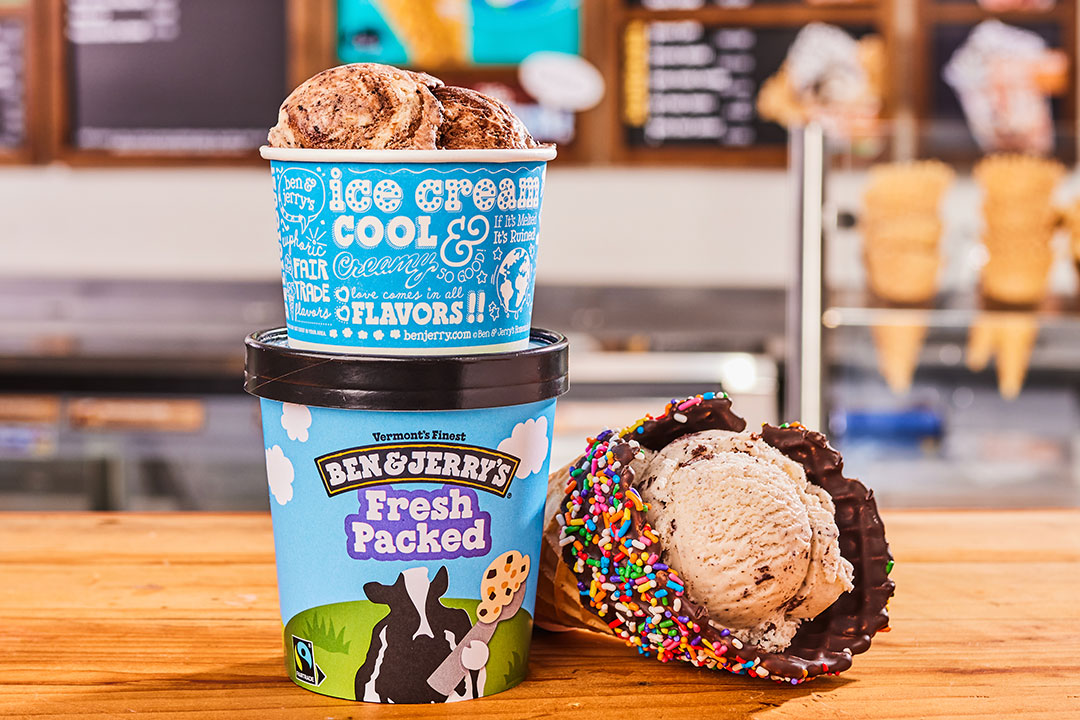 Ice cream pints next to an ice cream waffle cone