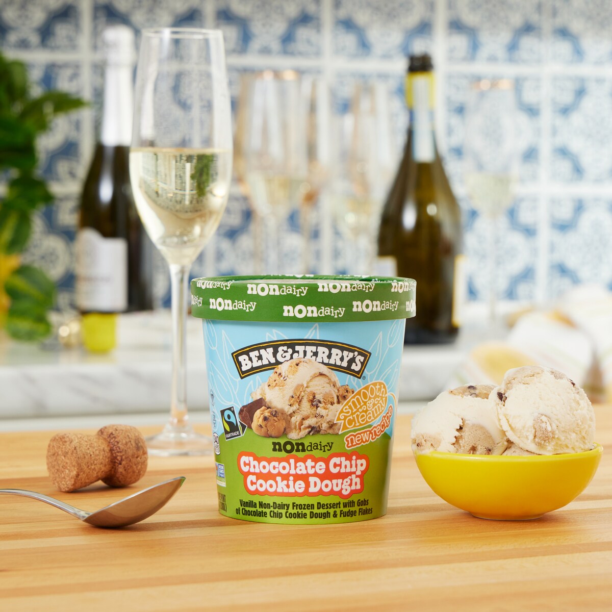 Pint of Ben & Jerry's Chocolate Chip Cookie Dough Non-Dairy vegan dessert with a glass of prosecco in a kitchen setting.