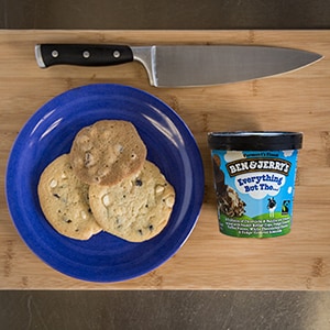 A Plate of cookies, pint of ice cream, and a knife