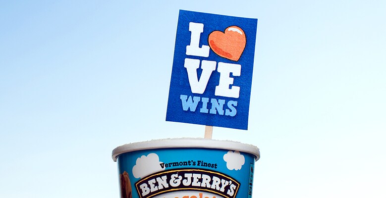A pint of ice cream with LOVE WINS sign stuck in it