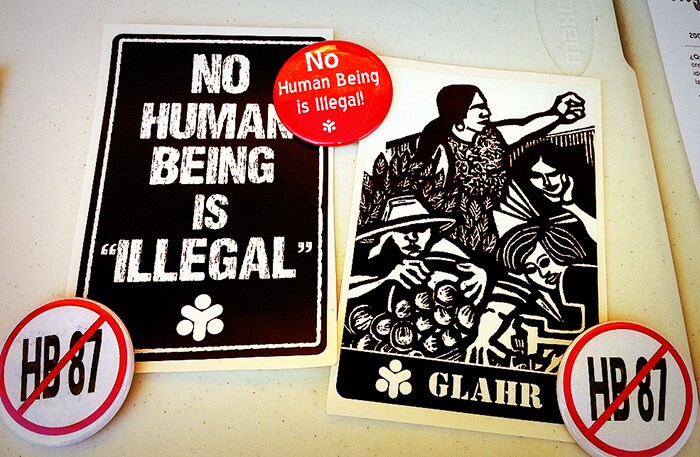 sign that says No human being is illegal