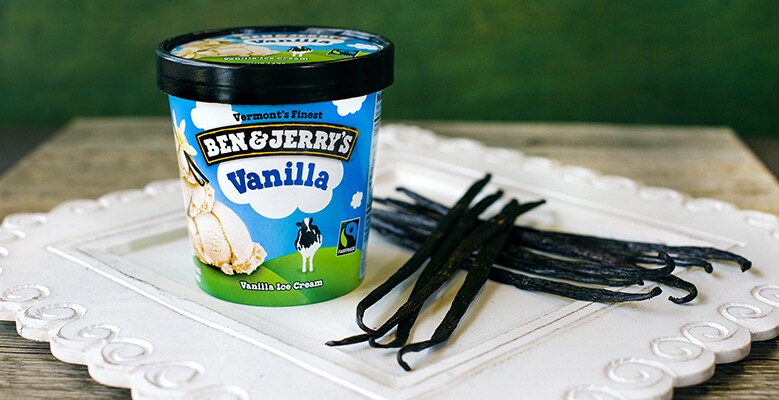 A pint of Vanilla Ben & Jerry's ice cream with a plate of vanilla beans
