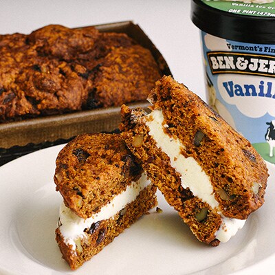 A pumpkin bread ice cream sandwich struts its stuff next to a pint of Ben & Jerry's Vanilla ice cream.
