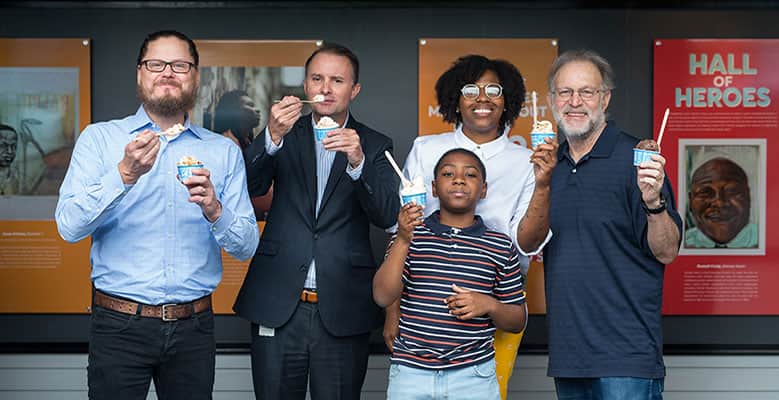 Andy and friends eating ice cream in front of art display