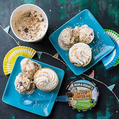 2 plates with a Vegan Coconut Seven Layer Bar Cupcake and ice cream
