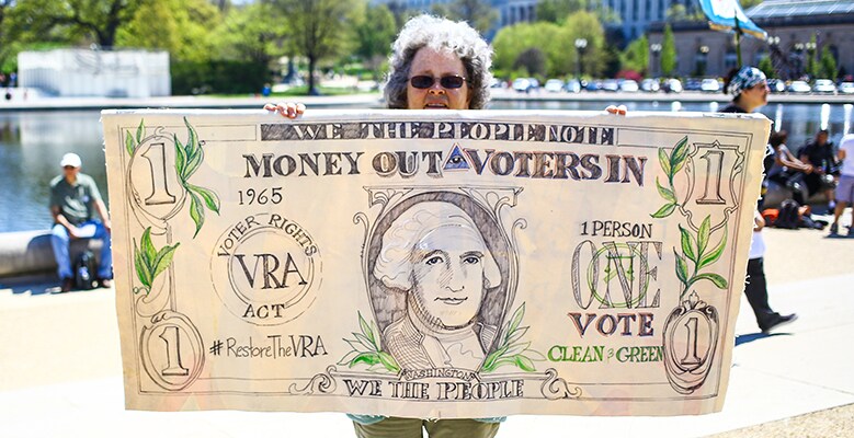 giant dollar bill saying Money Out Voters In