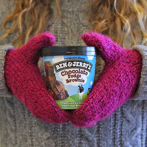 Wearing mittens holding a pint of Ben & Jerry's