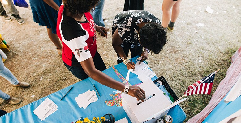 People fill out voter pledges, Ben & Jerry's
