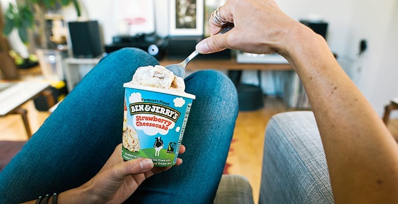 Strawberry Cheesecake Ben & Jerry's on the couch
