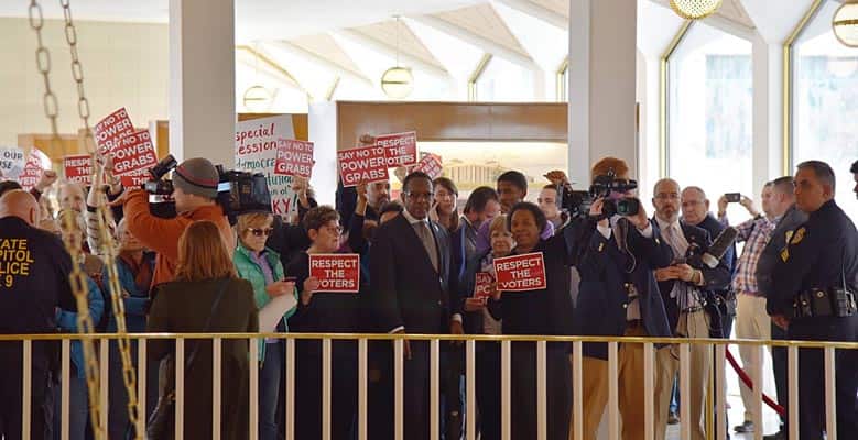 People holding signs at the North Carolina Statehouse