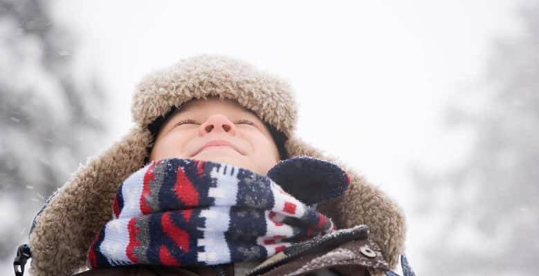 Boy wrapped up in a scarf and hat