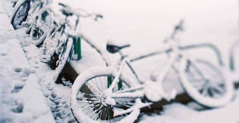 Bicycles covered in snow