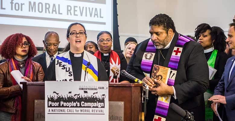 Rev Theoharis speaking at a podium