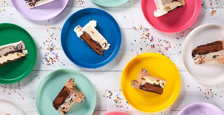 Slices of Ben & Jerry's ice cream cake on colorful plates.
