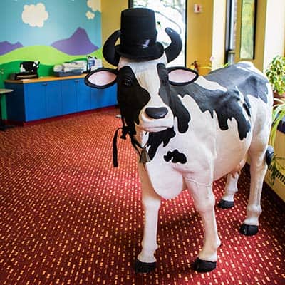 Life-sized fake cow at Ben & Jerry's offices, wearing a top hat