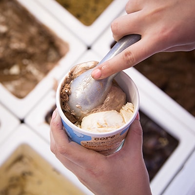 A Picture of putting another scoop of Ice Cream on the other side of the container