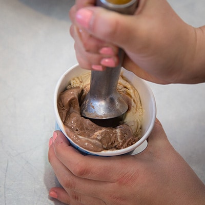 A picture of making a hole in the center of the ice cream