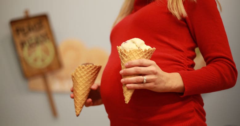 A pregnant women with two Ben & Jerry's ice cream cones