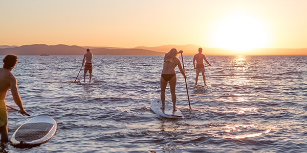 paddleboarders on lake