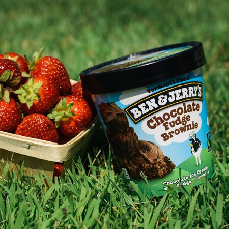 A Pint of Ben & Jerry's Chocolate Fudge Brownie with a carton of fresh strawberries