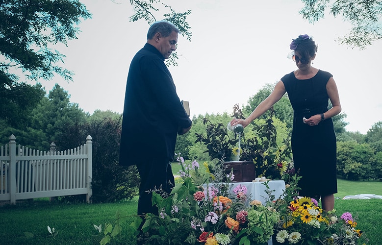 A man and women at a grave with flowers