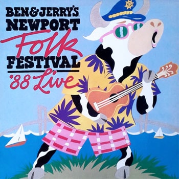 A Cow dressed in colorful clothing playing a guitar