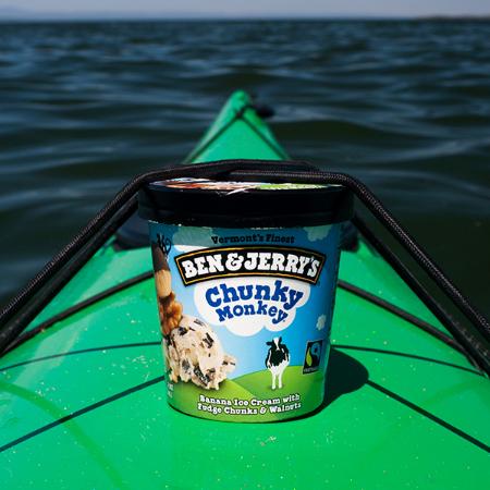 A pint of Ben & Jerry's Chunky Monkey floating on a canoe in water