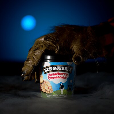 Strawberry Cheesecake being held by werewolf hand
